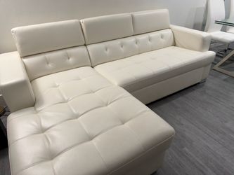 White leather sleep sofa with dinner set