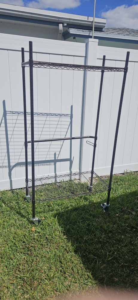LARGE METAL SHELVES. ON WHEELS 6FT BY 3FT