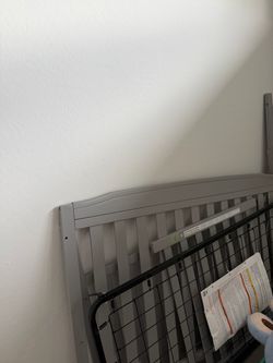 Grey crib with changing table
