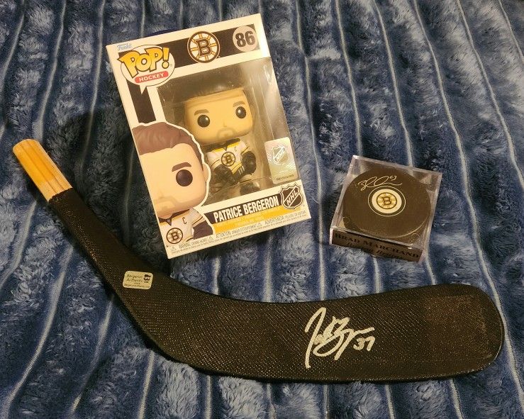 Boston Bruins Brad Marchand Autographed Puck And Adidas Jersey + Patrice Bergeron Autographed Stick And Funko