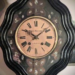 Rare beautiful antique French wall clock from 1800s with glass face and ebonized mother of pearl design.  Have seen these selling for $300 - $1,500.
