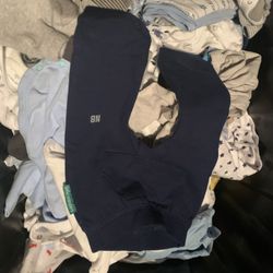 full bin of baby boy clothes 