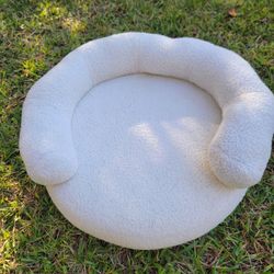 Round, bolster-style pet bed for small dog or cat
