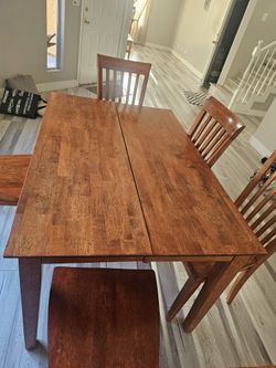 Solid wood extendable mission style dining table with 5 chairs, standing