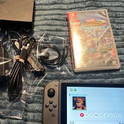 Nintendo switch with docking station and marvel super hero’s 2 game 