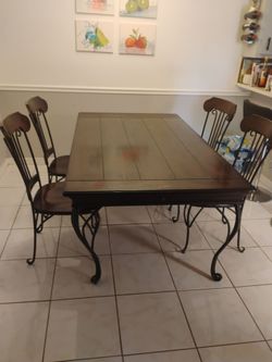 Table and 4 chairs, iron and wood...heavy.