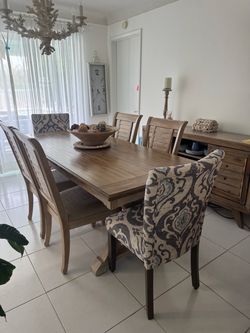 Dining table with 6 chairs and matching console.