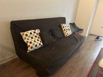 Futon/Sofa with brown cover and pillows