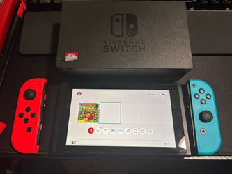 I’m Asking 180 For The Nintendo Switch. It’s In Good Condition Mid Scratches On The Screen. It Comes With A Sd Memory Card 64gbAnd A caring case, And 