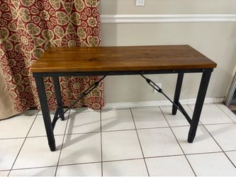 Rustic industrial writing desk with a solid wood top and black metal frame.
