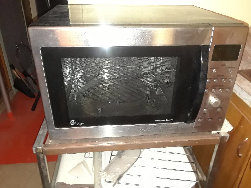 GE Microwave and convection oven, free stand included