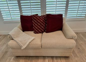 Beige  sofa- with burgundy  pillows