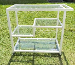 Selling a white bar cart with wheels.