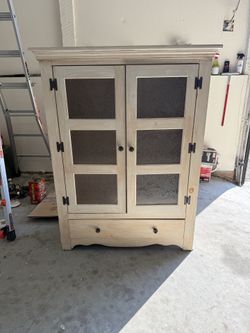 Antiqued cabinet with decorative glass