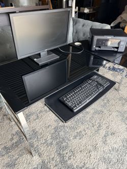 Black Glass desk with metal legs. Also included are new leather computer chair, Acer Monitor, Epson printer and Logitech keyboard.