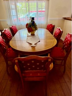 Dining table and 7 antique newly upholstered chairs. Includes 2 leaves and protective pads.