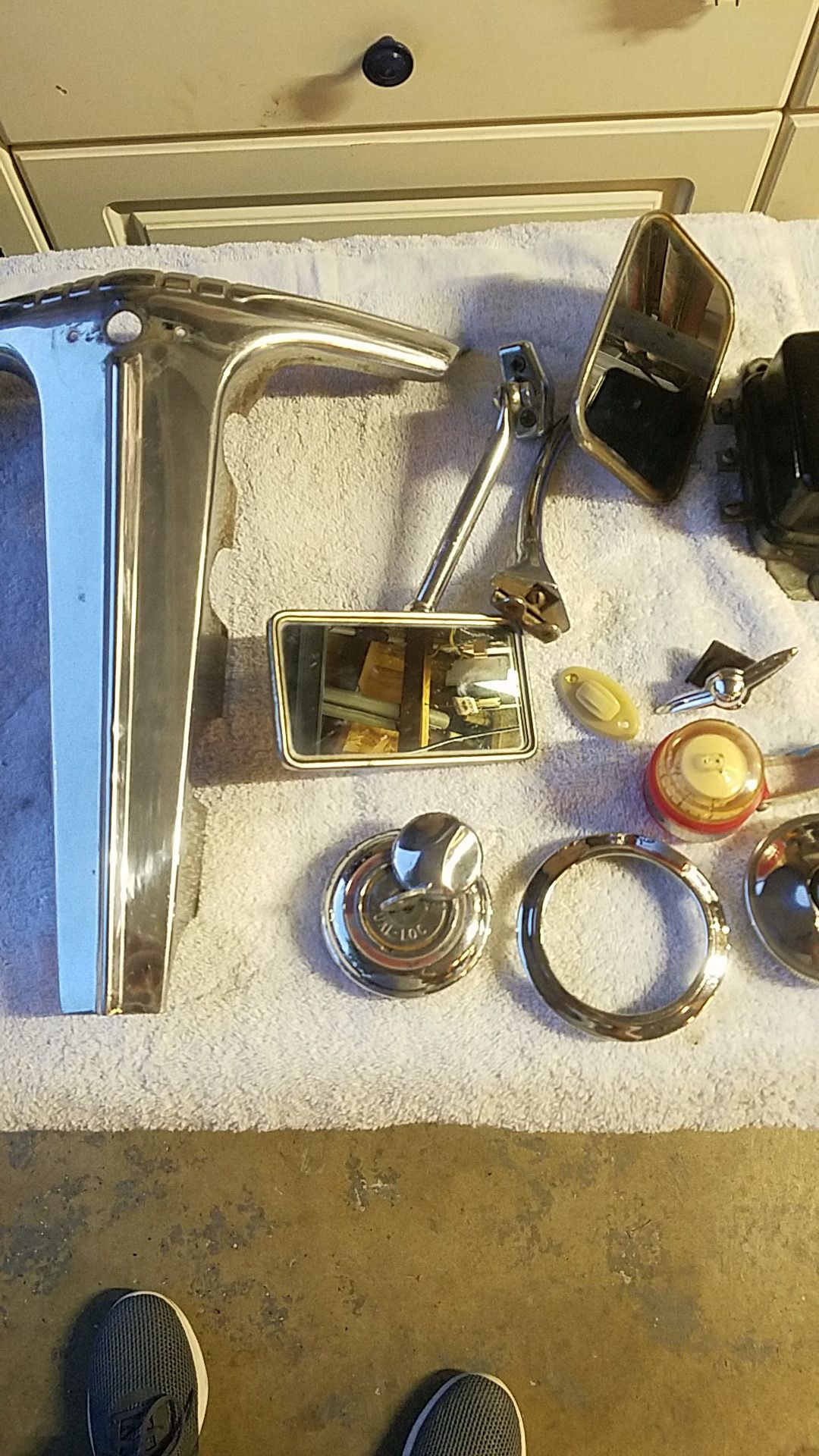 Parts for a 1946-1948 Chevy grill. Horn button air way compas dome light switch and gas cap. All original