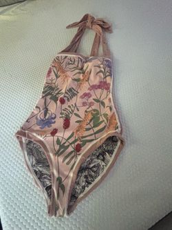 Beautiful reversible one-piece swimsuit from Visual Mood has a pink base with a multi-colored floral print. Size unknown