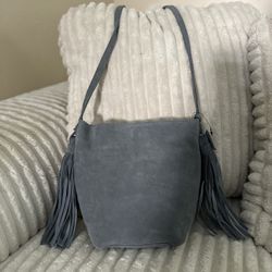 NWT Monserat DeLucca Italian Leather Suede crossbody bag. Hobo Bag. Shoulder Bag. Made in Italy. The bag has tassels on each side.
