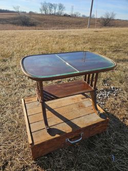 vintage-style retro wooden side table featuring a glass top insert and a lower shelf & claw feet