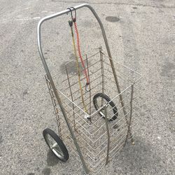 A GROCERY SHOPPING CART /LAUNDRY CART WITH TWO BUNGEE CORDS LITE WEIGHT AND STURDY FOLDS FLAT USED IN GOOD CONDITION $20.00