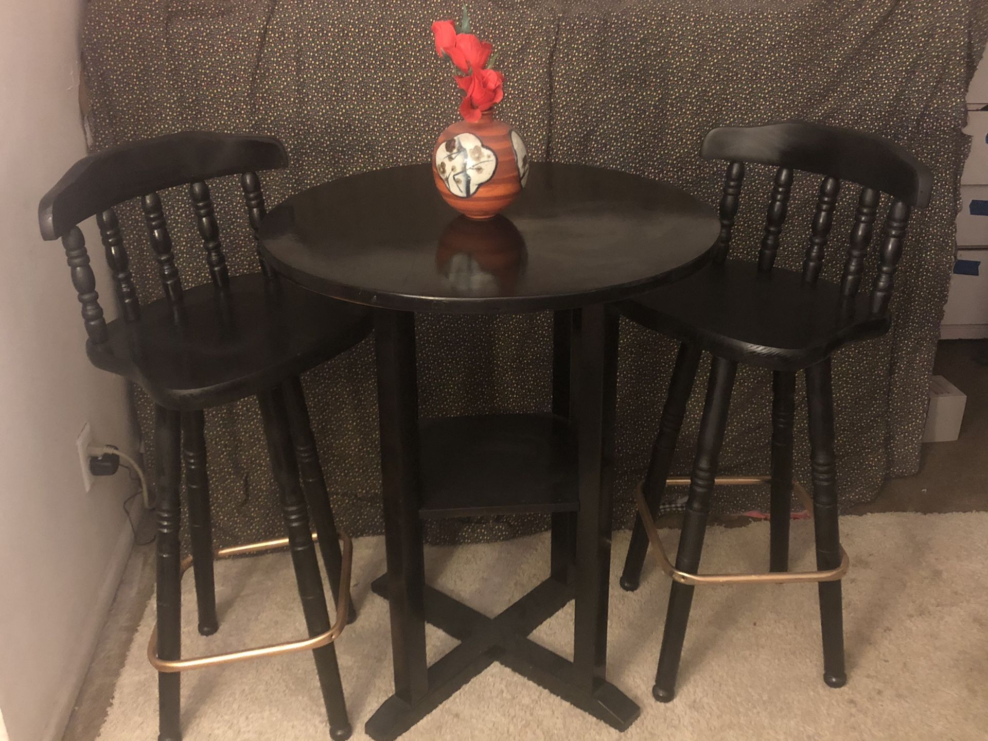 Black MCM bar table and 4 bar stools with gold foot rests