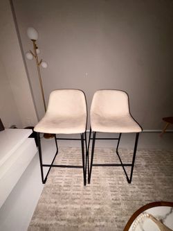 Two beige high chairs with black headware 27inch tall