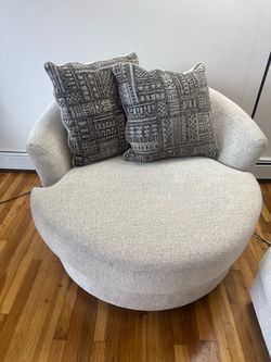 A couch and An Oversized Round Swivel Accent Chair with a matching coach maching set