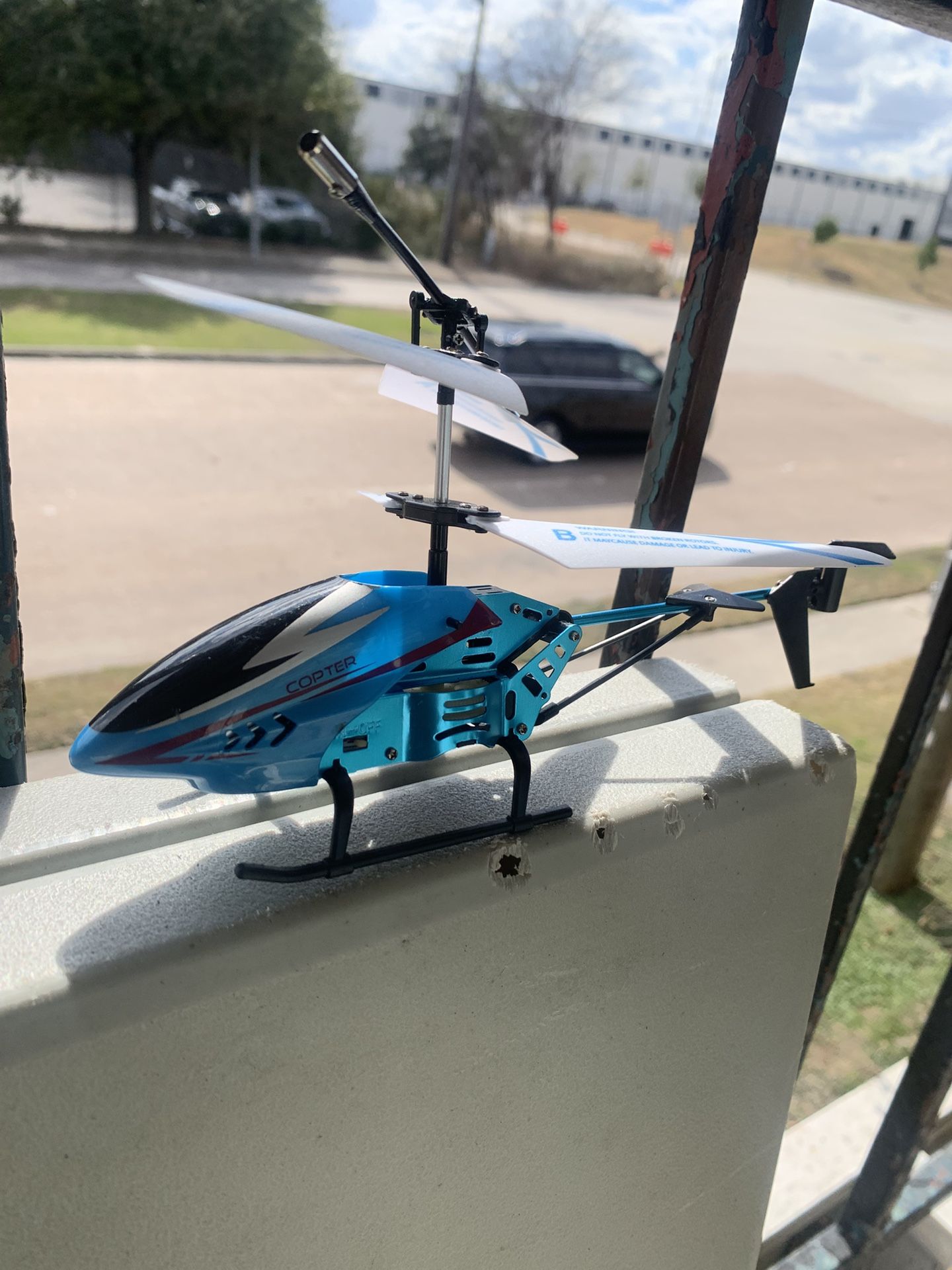 mini remote-control (RC) toy helicopter in blue and black.