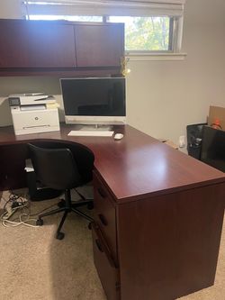 L-shaped executive office desk with a matching overhead hutch