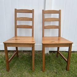 two lightweight wood dining chairs