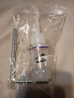 Bottle of 100 percent silicone treadmill belt lubricant oil and an Allen Wrench. For Treadmill and Walking Pad Maintenance.