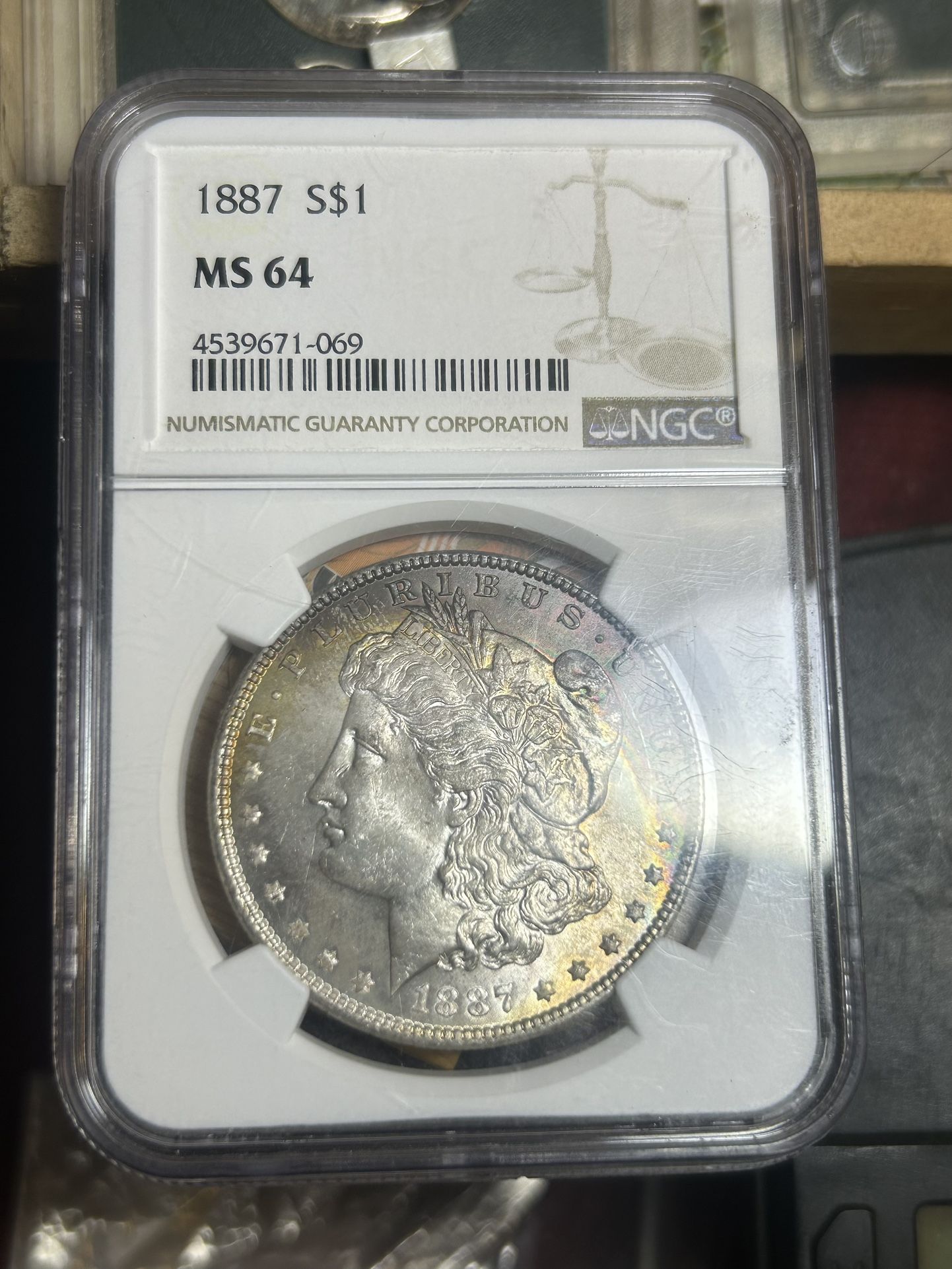 Morgan Silver Dollar 1887 MS64 with Nice, full spectrum rainbow tong crescent