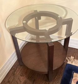 Round glass top and dark wood table