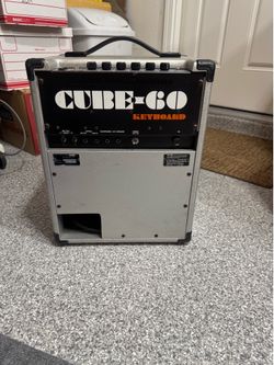 Vintage Roland Cube-60 Keyboard Amplifier from the 1980s, recognizable by its silver casing and black control panel.