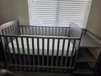 Metal Crib with Mattress, Attached Shelves and Changing Pad