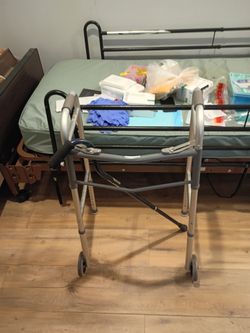 Medical supplies hospital bed, Walker, and a black cane