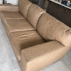 One year old Tan Leather couch