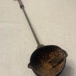 Vintage Primitive Cast Iron Ladle with Long, Textured Handle and Round Bowl