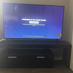 Roku 55’ Television and tv stand