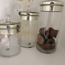 3 glass and gold canisters