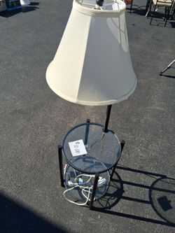 Glass table with attached lamp