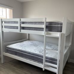 Full over Full bunk bed. Dark walnut,grey & white-$499. Full mattresses -$125.00 each. Assembly not included. Taxes included. Free delivery.  Se habla