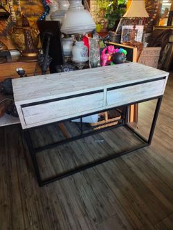 Rustic industrial-style console table with two drawers and a black metal frame