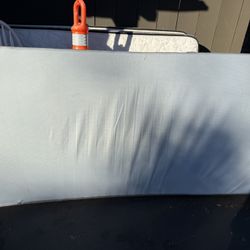 Twin-size foam mattress with zippered cover. 