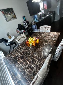 Dinner table and chairs .