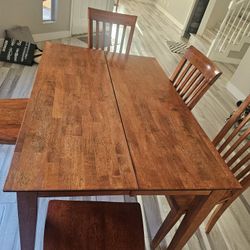 Solid wood extendable mission style dining table with 5 chairs, standing