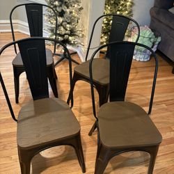 4 industrial-style metal dining chairs with wood