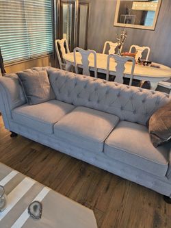 Grey tufted sofa