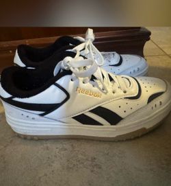 Reebok white sneakers with black accents and gold logo